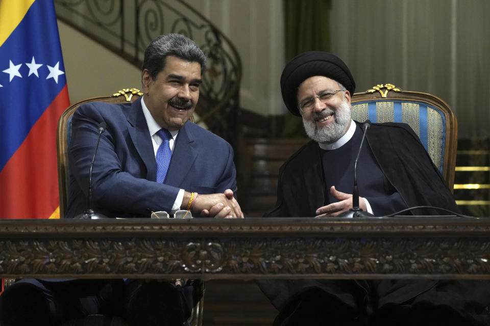 Iranian President Ebrahim Raisi, right, and his Venezuelan counterpart Nicolas Maduro shake hands at the conclusion of their joint news briefing at the Saadabad Palace in Tehran, Iran, Saturday, June 11, 2022. (AP Photo/Vahid Salemi)