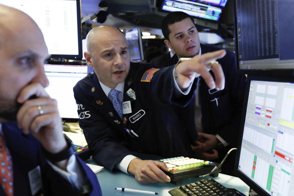 FILE- In this Jan. 4, 2019, file photo Mario Picone, center, works with fellow specialists on the floor of the New York Stock Exchange. The U.S. stock market opens at 9:30 a.m. EST on Monday, Jan. 7. (AP Photo/Richard Drew, File)