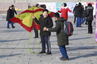 North Korean boys prepare to fly a kite at the Kim Il Sung Square in Pyongyang, North Korea, Saturday, Jan. 25, 2020, on the occasion of Lunar New Year. (AP Photo/Jon Chol Jin)