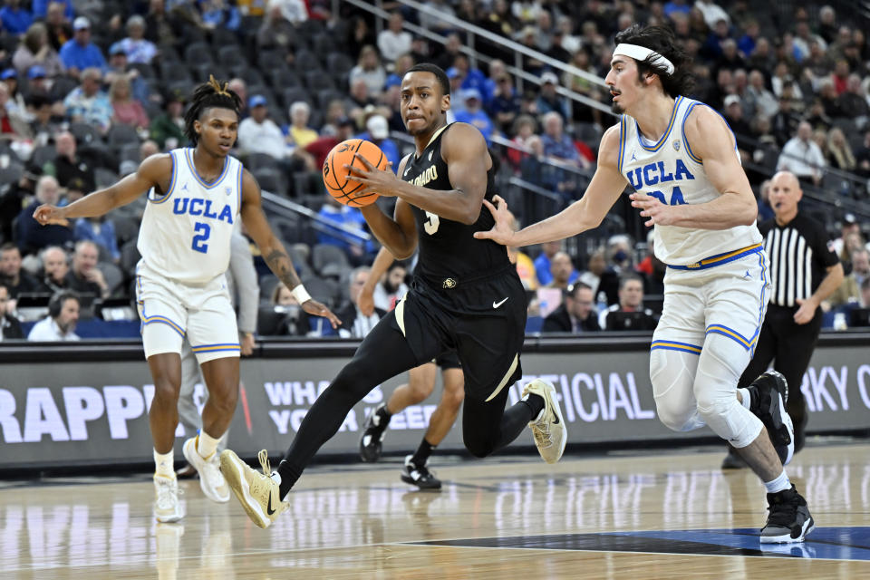 Colorado guard Jalen Gabbidon (3) drives the ball against UCLA guard Dylan Andrews (2) and guard Jaime Jaquez Jr. during the first half of an NCAA college basketball game in the quarterfinals of the Pac-12 Tournament, Thursday, March 9, 2023, in Las Vegas. (AP Photo/David Becker)