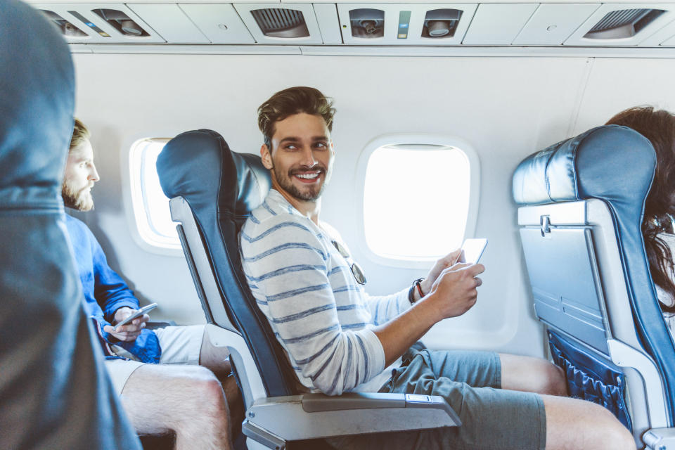 A man on a plane smiling