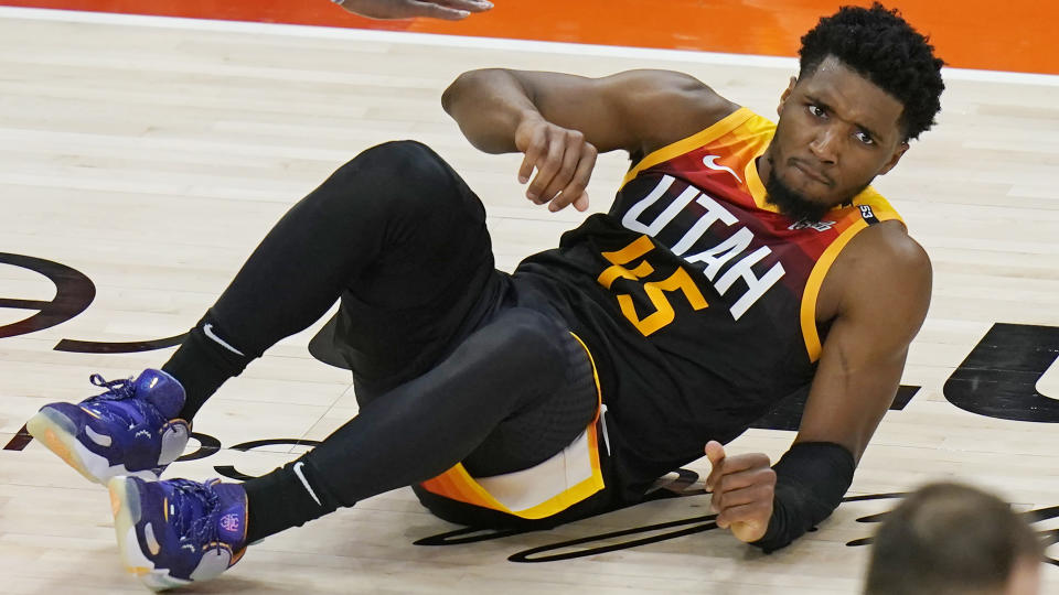 Utah Jazz guard Donovan Mitchell rolls on the court after being fouled by Los Angeles Clippers guard Paul George during the second half of Game 2 of a second-round NBA basketball playoff series Thursday, June 10, 2021, in Salt Lake City. (AP Photo/Rick Bowmer)