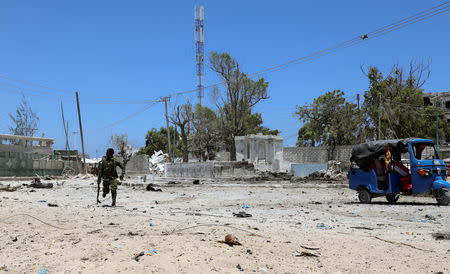 A Somali soldier runs to hold position as al-Shabaab militia storms a government building in Mogadishu, Somalia March 23, 2019. REUTERS/Feisal Omar