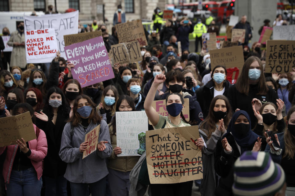 Women holding posters walk towards Parliament Square during a 'Kill the Bill' protest in London, Saturday, April 3, 2021. The demonstration is against the contentious Police, Crime, Sentencing and Courts Bill, which is currently going through Parliament and would give police stronger powers to restrict protests. (AP Photo/Matt Dunham)