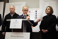 Attorney Jeff Anderson speaks as Joe Iacono, left, and Cindy Yesko listen during a news conference with , Wednesday, March 20, 2019, in Chicago. Advocates for clergy abuse victims say their list of 395 priests or lay people in Illinois who have been publicly accused of sexually abusing children is far more extensive than the names already released by the state's six dioceses. (AP Photo/Kiichiro Sato)