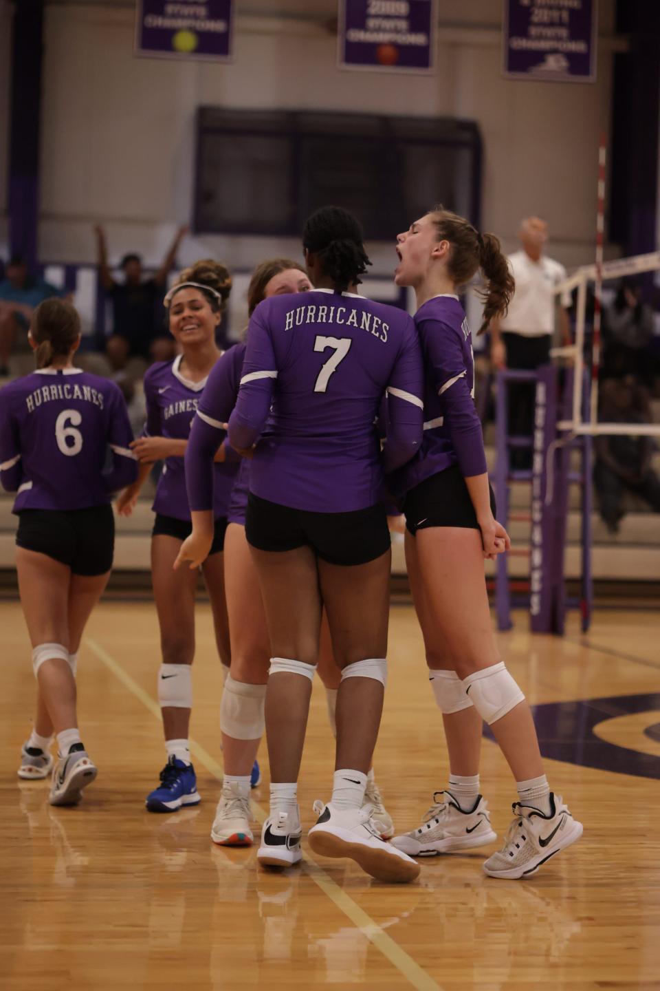 Charlotte Gravlee (fight) celebrates after a block with Nicole Ellis (7) against Vanguard at Gainesville High School on Tuesday, Aug. 30, 2022.