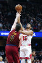 Chicago Bulls' Chandler Hutchison (15) shoots over Cleveland Cavaliers' Kevin Love (0) in the second half of an NBA basketball game, Saturday, Jan. 25, 2020, in Cleveland. The Bulls defeated the Cavaliers 118-106. (AP Photo/Ron Schwane)