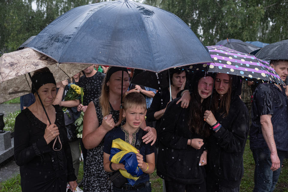 Close relatives of Anton Savytskyi cry during his funeral service in Bucha, Ukraine, on Aug. 13, 2022. Savytskyi, 43, was killed in Bakhmut, Donetsk region, on Aug. 7.