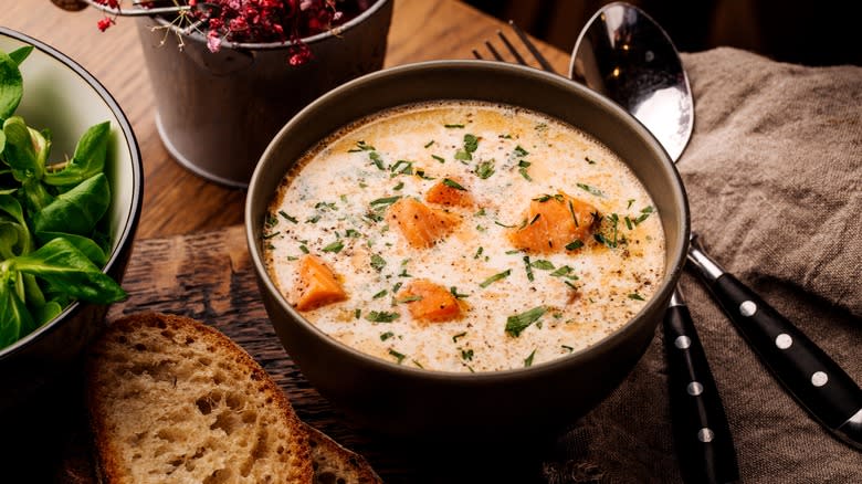 Salmon soup in black bowl