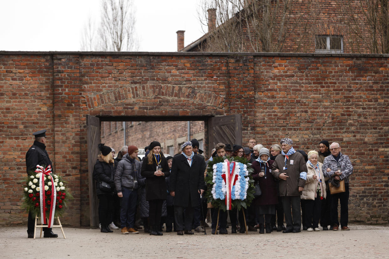 Holocaust survivors and former Auschwitz inmates attend a wreath lying ceremony in front of the Death Wall in the former Nazi German concentration and extermination camp Auschwitz during ceremonies marking the 78th anniversary of the liberation of the camp in Oswiecim, Poland, Friday, Jan. 27, 2023. (AP Photo/Michal Dyjuk)