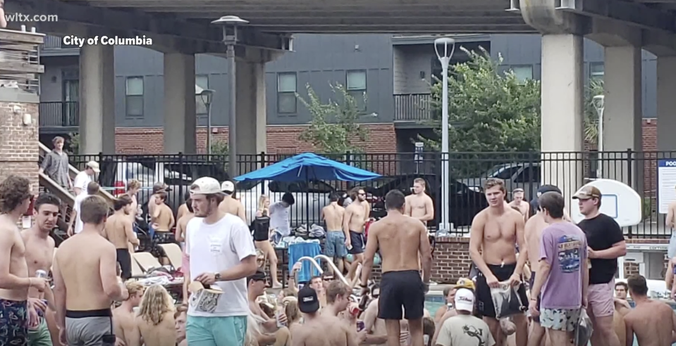 Pictured are dozens of people at a pool party in South Carolina ignoring social distancing rules. 