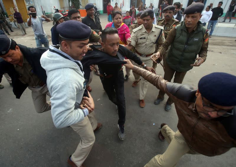 Policemen detain a demonstrator during a protest after India's parliament passed Citizenship Amendment Bill, in Agartala