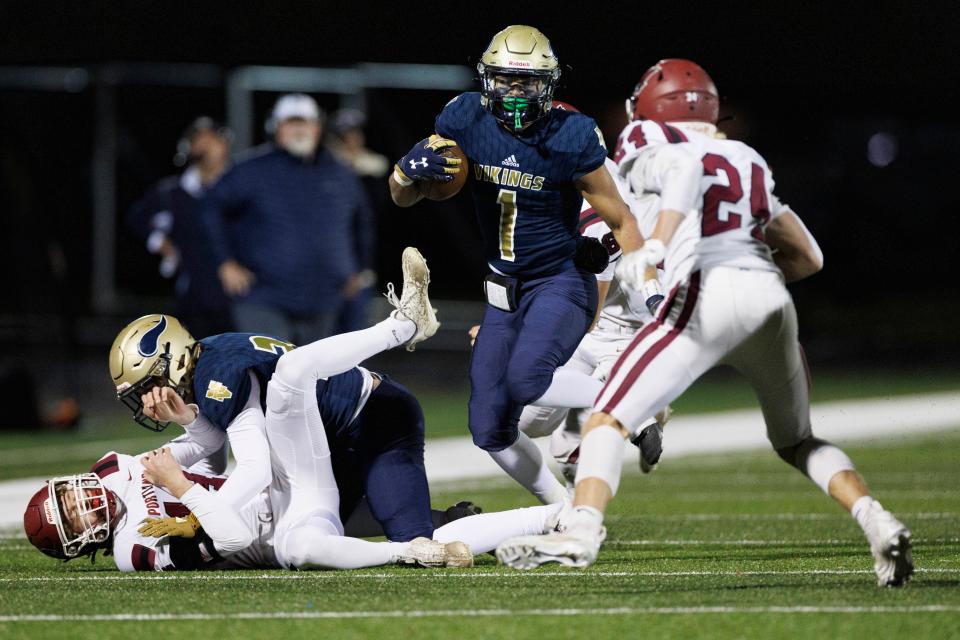 Niles’ Julian Means-Flewellen (1) runs with the ball during the Portland-Niles high school football game on Friday, November 10, 2023, at Viking Stadium in Niles, Michigan.