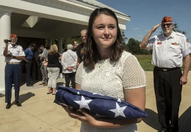 Downingtown resident Justine Newman hold the flag she was presented on Aug. 29, 2019 during a memorial service for 14 unclaimed veterans. They included nine she identified.