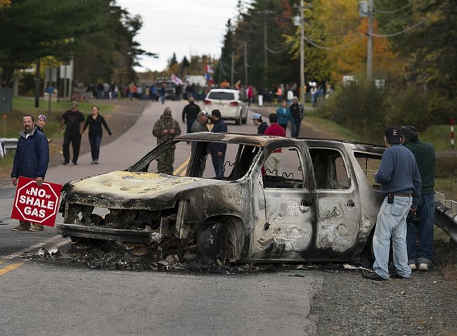 A police vehicle is seen in Rexton, N.B. as police began enforcing an injunction to end an ongoing demonstration against shale gas exploration in eastern New Brunswick on Thursday, Oct.17, 2013. Police say at least five RCMP vehicles were destroyed after they were set ablaze and at least one shot was fired by someone other than a police officer at the site of the protest in Rexton.THE CANADIAN PRESS/Andrew Vaughan