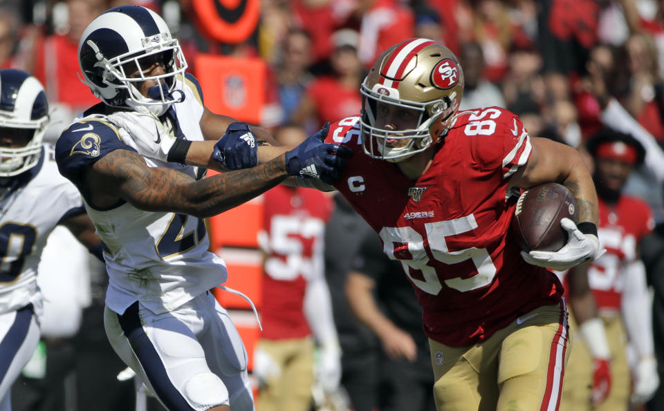 San Francisco 49ers tight end George Kittle (85) stiff-arms Los Angeles Rams cornerback Marcus Peters (22) during the first half of an NFL football game Sunday, Oct. 13, 2019, in Los Angeles. (AP Photo/Alex Gallardo)