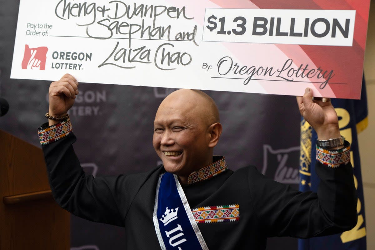 Powerball winner Cheng ‘Charlie’ Saephan celebrates his win at a news conference in Oregon (AP)