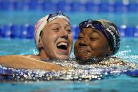 Simone Manuel and Abbey Weitzeil react after the women's 50 freestyle during wave 2 of the U.S. Olympic Swim Trials on Sunday, June 20, 2021, in Omaha, Neb. (AP Photo/Jeff Roberson)