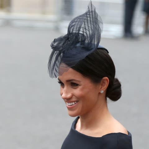 The Duchess of Sussex wore a neat chignon at yesterday's RAF centenary celebrations - Credit: Steve Parsons/PA