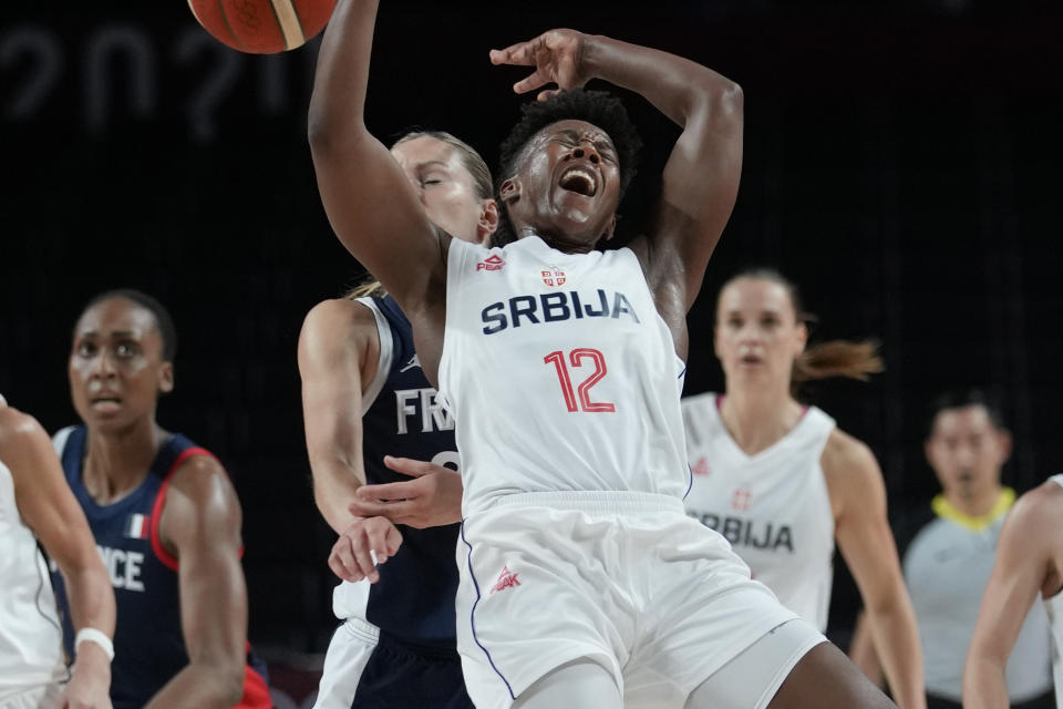 Serbia's Yvonne Anderson (12) is fouled by France's Marine Johannes (23) during a women's basketball bronze medal game at the 2020 Summer Olympics, Saturday, Aug. 7, 2021, in Saitama, Japan. (AP Photo/Eric Gay)