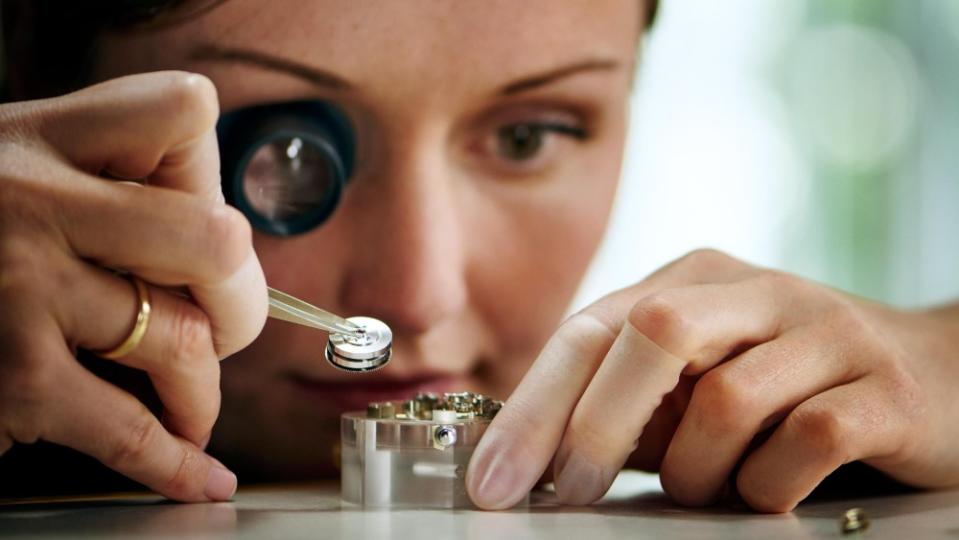 A. Lange & Söhne watchmaker Sindy inserts the patented mainspring barrel into the L043.6 caliber of the Zeitwerk