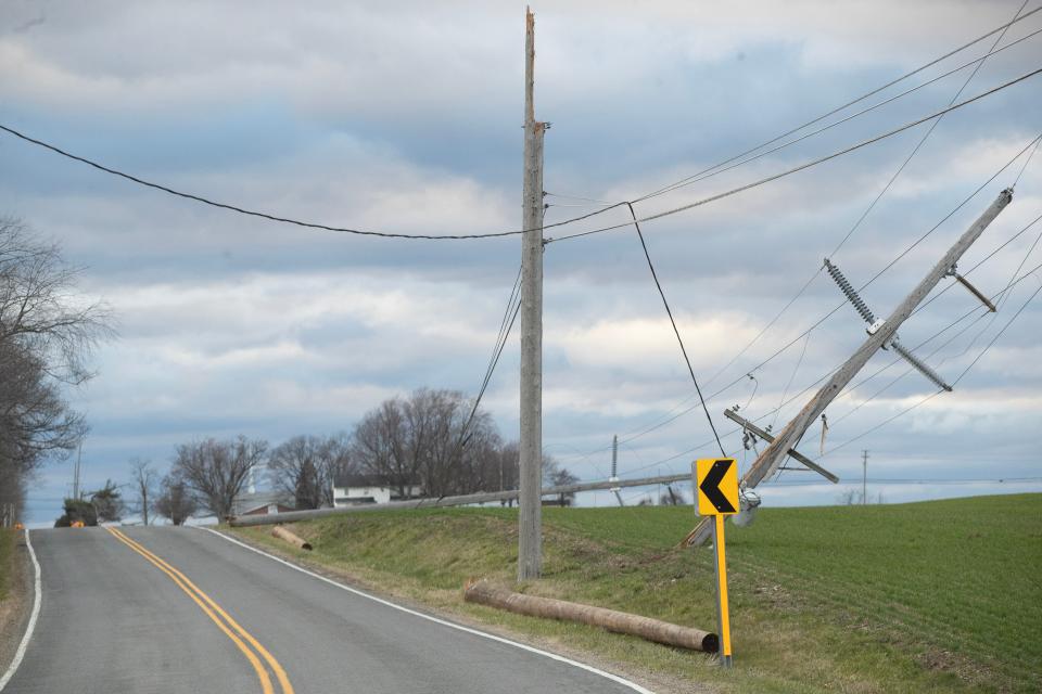 High winds toppled utility poles, which took down power lines Saturday on Wooster Street in Stark County's Tuscarawas Township.