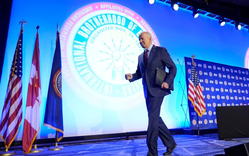Joe Biden walks off stage following a speech in Washington in April