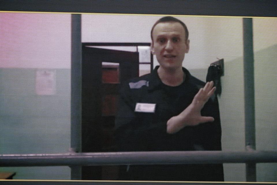 FILE - Russian opposition leader Alexei Navalny, seen on a TV screen as he appears in a video link provided by the Russian Federal Penitentiary Service from the colony in Melekhovo, Vladimir region, during a hearing at the Russian Supreme Court in Moscow, Russia, on Wednesday, Aug. 23, 2023. Navalny, 47, is serving a 19-year prison term on extremism charges. (AP Photo/Alexander Zemlianichenko, File)