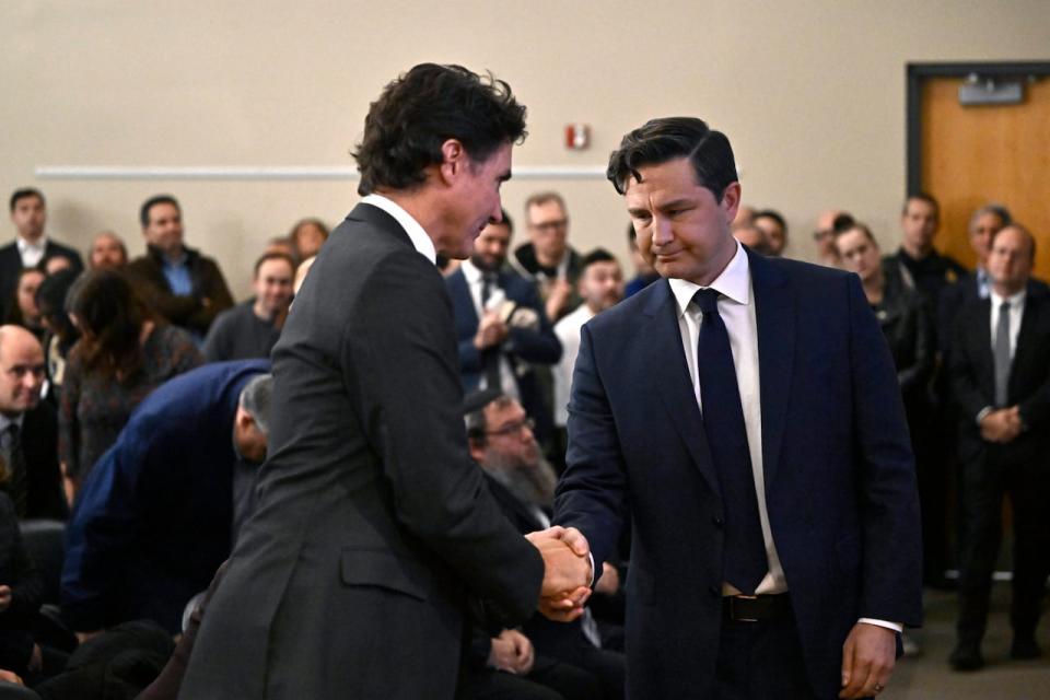 Conservative Leader Pierre Poilievre shakes hands with Prime Minister Justin Trudeau after Poilievre's remarks at a rally in support of Israel at the Soloway Jewish Community Centre in Ottawa on Oct. 9, 2023. (Justin Tang/The Canadian Press - image credit)