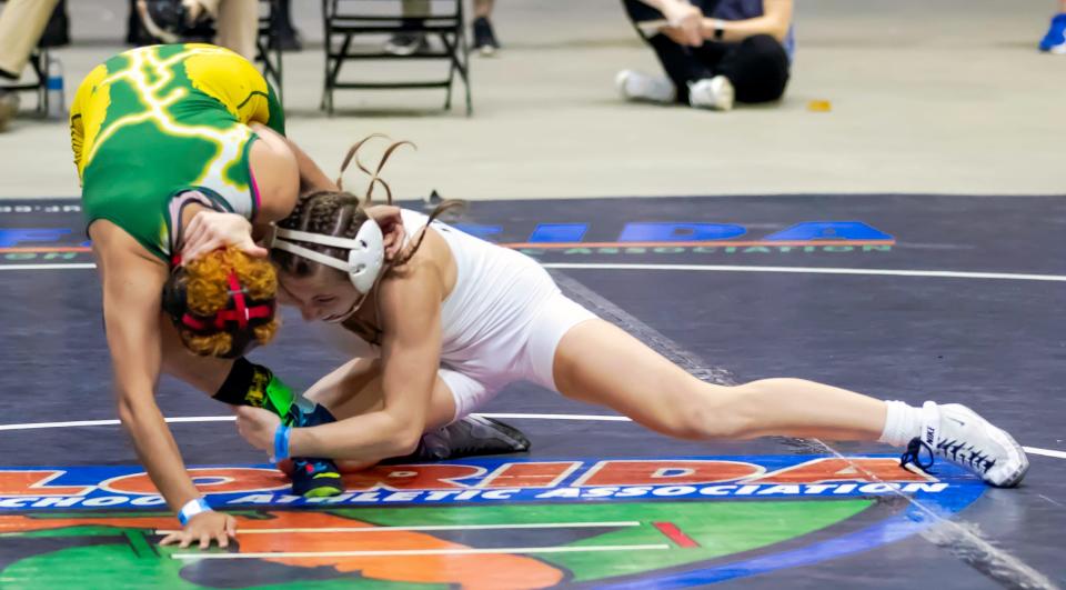 Venice High's Milana Borrelli, right, puts an ankle pick on Liberty High's Delialah Betances in the 120-pound final of the FHSAA Wrestling Championships on March 2 at Silver Spurs Arena in Kissimmee. Borrelli won her second straight state title with a 10-0 major decision over Betances.