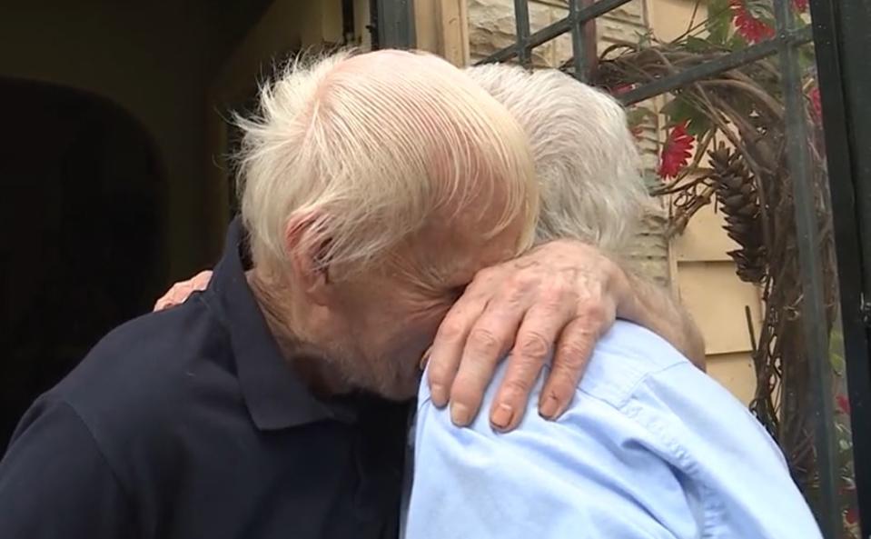 Ric Morgan hugs Alice Harrington on the steps of his Memphis home.