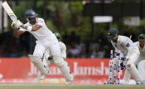 Sri Lanka's Dinesh Chandimal (L) is bowled out by Pakistan's Yasir Shah (not pictured) during the second day of their second test cricket match against Pakistan in Colombo June 26, 2015. REUTERS/Dinuka Liyanawatte