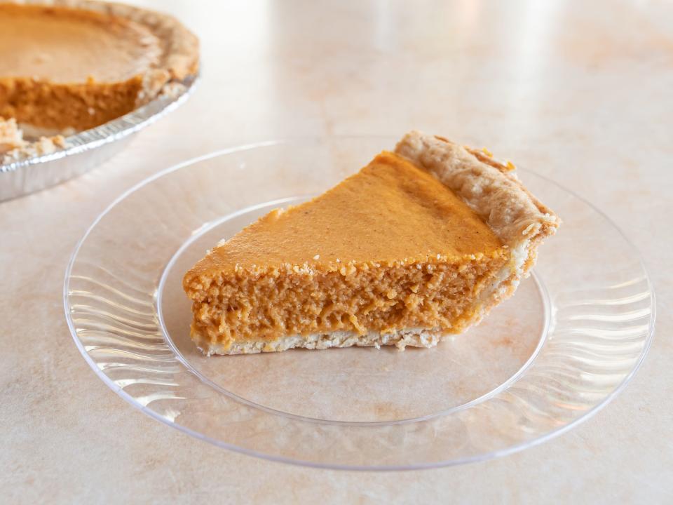 A slice of pumpkin pie from Walmart on a clear plate