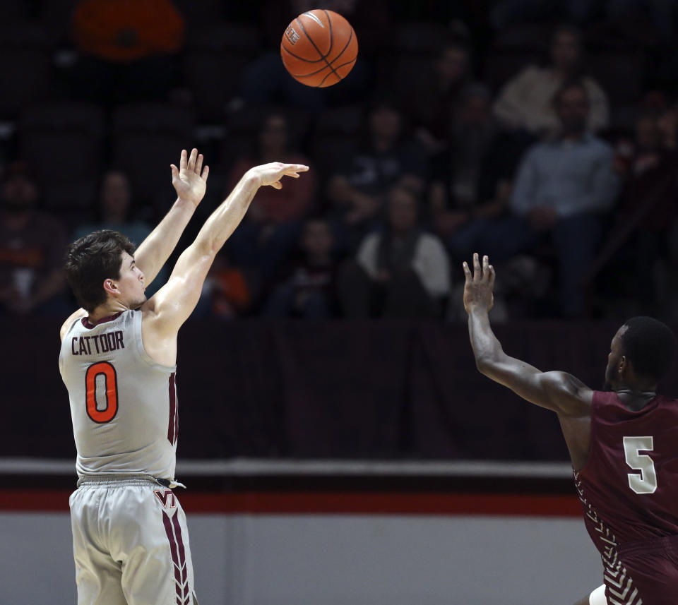 Virginia Tech's Hunter Cattoor (0) shoots a three-point basket over the defense of Maryland-Eastern Shore's Da'Shawn Phillip (5) in the first half of an NCAA college basketball game in Blacksburg, Va., Sunday, Dec. 29 2019. (Matt Gentry/The Roanoke Times via AP)