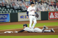 Arizona Diamondbacks' Pavin Smith, bottom, dives into third base after hitting an RBI triple as Houston Astros third baseman Alex Bregman (2) waits for the throw during the seventh inning of a baseball game Friday, Sept. 18, 2020, in Houston. (AP Photo/David J. Phillip)