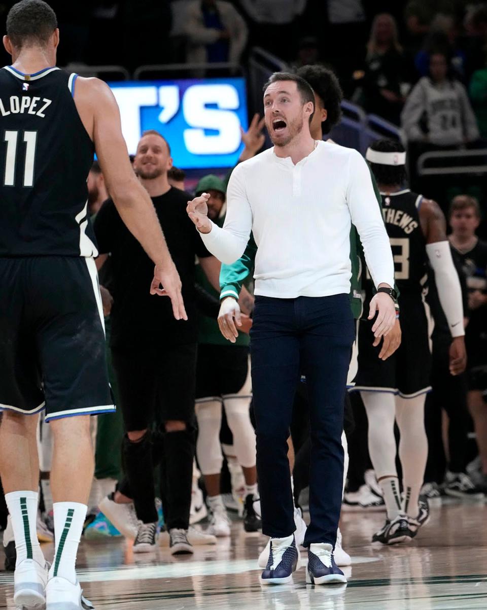 Milwaukee Bucks guard Pat Connaughton (24), who’s injured, celebrates with his team in the final seconds during the second half of their game against the Detroit Pistons in Milwaukee, Wis., on Monday, Oct. 31, 2022. The Bucks beat the Pistons 110-108.