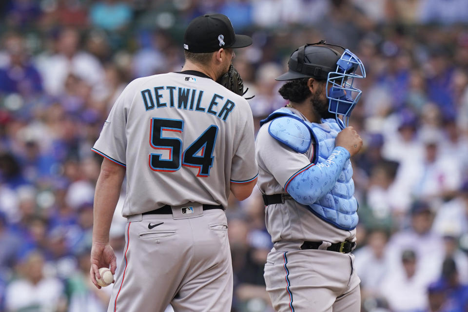 Miami Marlins relief pitcher Ross Detwiler, left, talks with catcher Jorge Alfaro during the fifth inning of a baseball game against the Chicago Cubs in Chicago, Sunday, June 20, 2021. (AP Photo/Nam Y. Huh)
