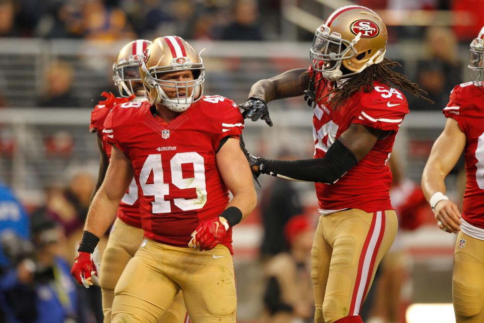 San Francisco 49ers fullback Bruce Miller (49) is congratulated by outside linebacker Ray-Ray Armstrong (54) after making a tackle on a punt return against the St. Louis Rams in overtime at Levi's Stadium.