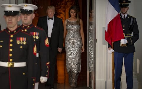 U.S. President Donald Trump and U.S. First Lady Melania Trump arrive to greet Emmanuel Macron, France's president, and Brigitte Macron, France's first lady - Credit: Bloomberg