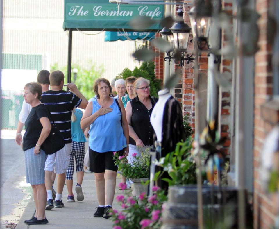 People walk along the Water St. side of The Cotton Exchange in Wilmington, N.C. on Saturday, August 13, 2016. The complex has approximately 25 shops and restaurants, and it's one of the many shopping venues in the Wilmington area.