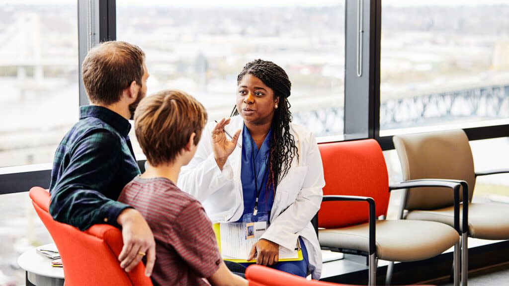 Doctor speaks with a father and son