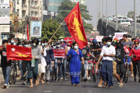 A crowd of protesters march in Yangon, Myanmar Sunday, Feb. 7, 2021. Thousands of people rallied against the military takeover in Myanmar's biggest city on Sunday and demanded the release of Aung San Suu Kyi, whose elected government was toppled by the army that also imposed an internet blackout. (Kyodo News via AP)