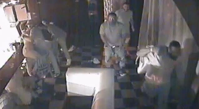 Three men barge through a door before one appears to open fire. Source: New York Police Department