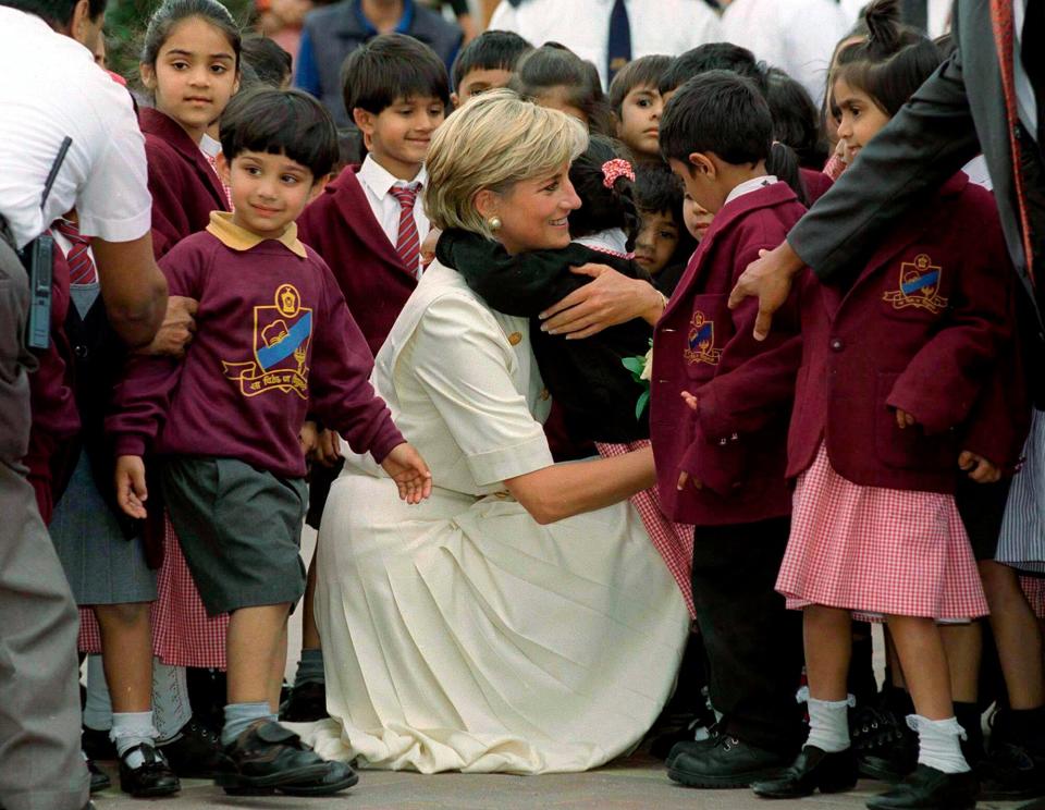Diana Princess Of Wales Crouching Down To Embrace One Of The Many Pupils At The Swaminarayan School Whom She Met During Her Visit To The Shri Swaminarayan Mandir In Neasden,london