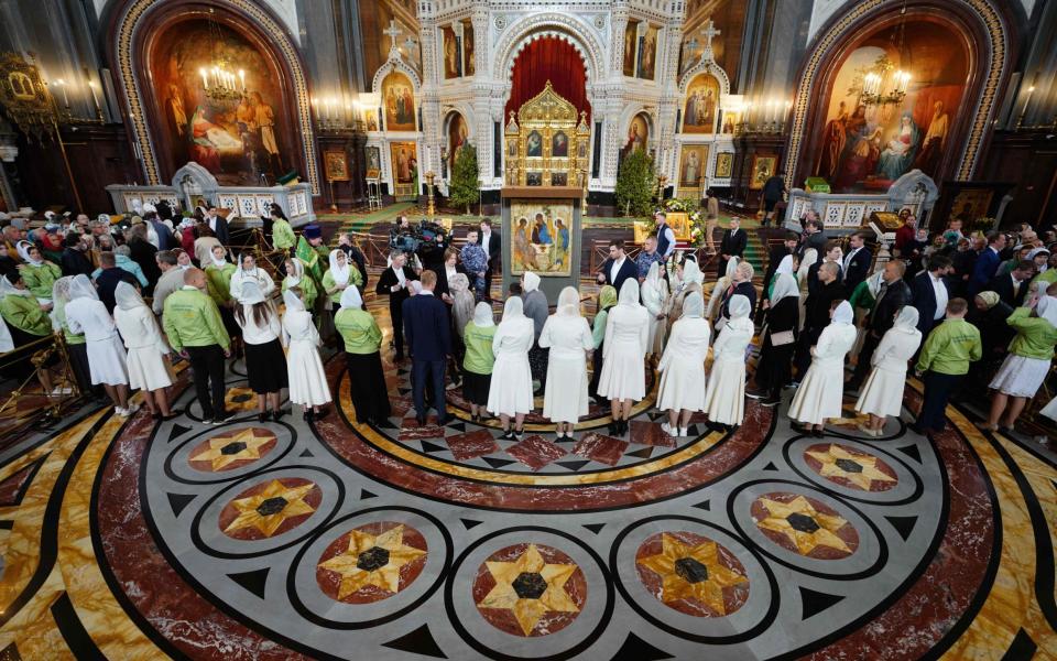 Russian Orthodox believers gather in the Christ the Saviour Cathedral to see the Trinity - AFP/AFP