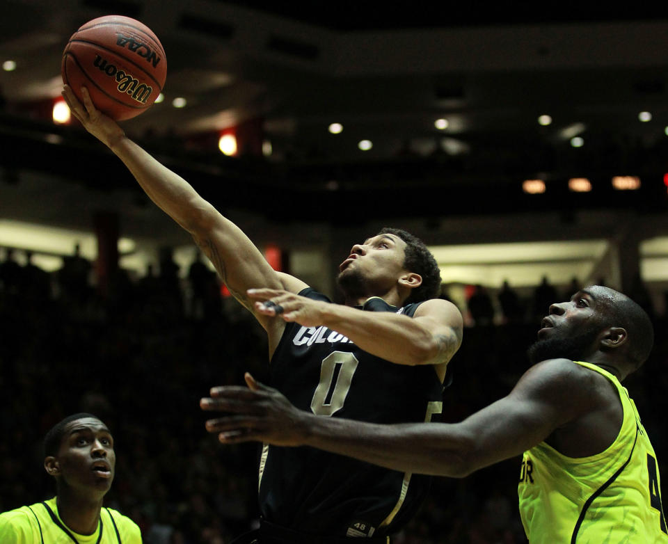 ALBUQUERQUE, NM - MARCH 17: Askia Booker #0 of the Colorado Buffaloes shoots against Quincy Acy #4 of the Baylor Bears in the second half of the game during the third round of the 2012 NCAA Men's Basketball Tournament at The Pit on March 17, 2012 in Albuquerque, New Mexico. Baylor won 80-63 in regualtion. (Photo by Ronald Martinez/Getty Images)