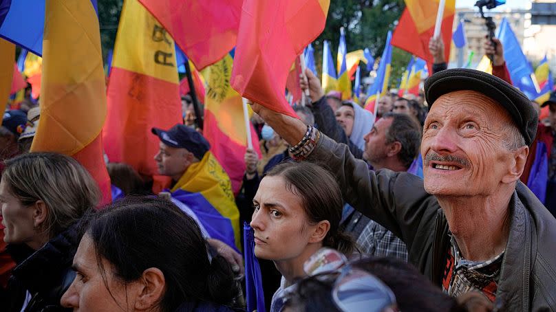 People wave flags during an anti-government protest organised by the far-right Alliance for the Unity of Romanians or AUR, in Bucharest, Romania, Saturday, Oct. 2, 2021.