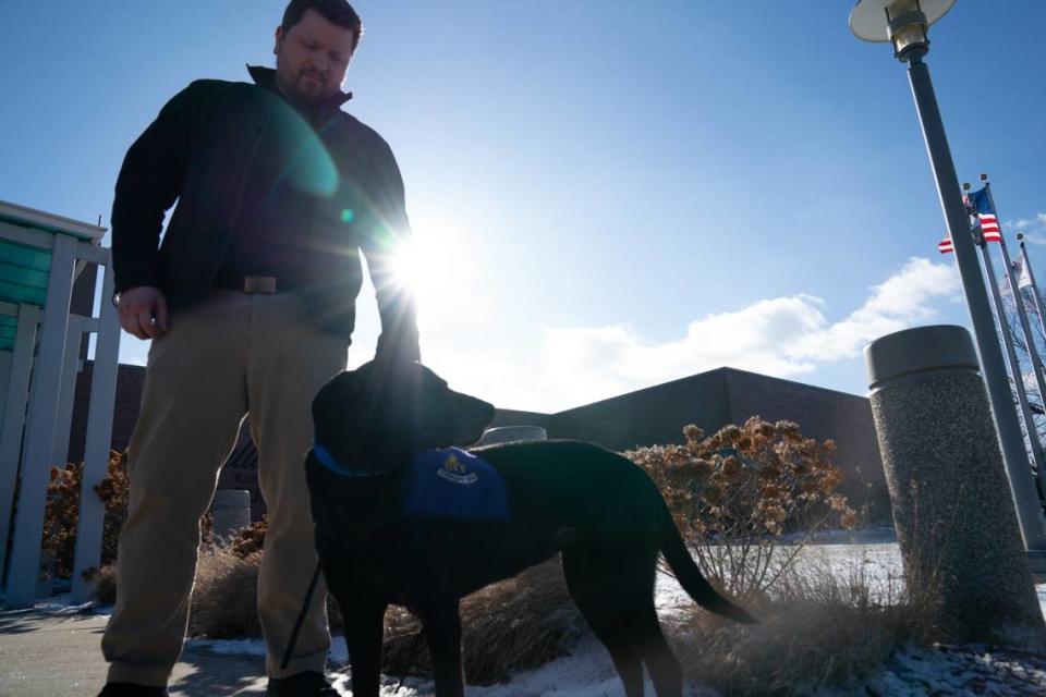 O’Fallon police department communications supervisor Erik Mensen takes JuJube for a walk on Jan. 19, 2024. JuJu is a therapy dog and is the latest implement in the department’s mission to increase mental health resources for first responders.