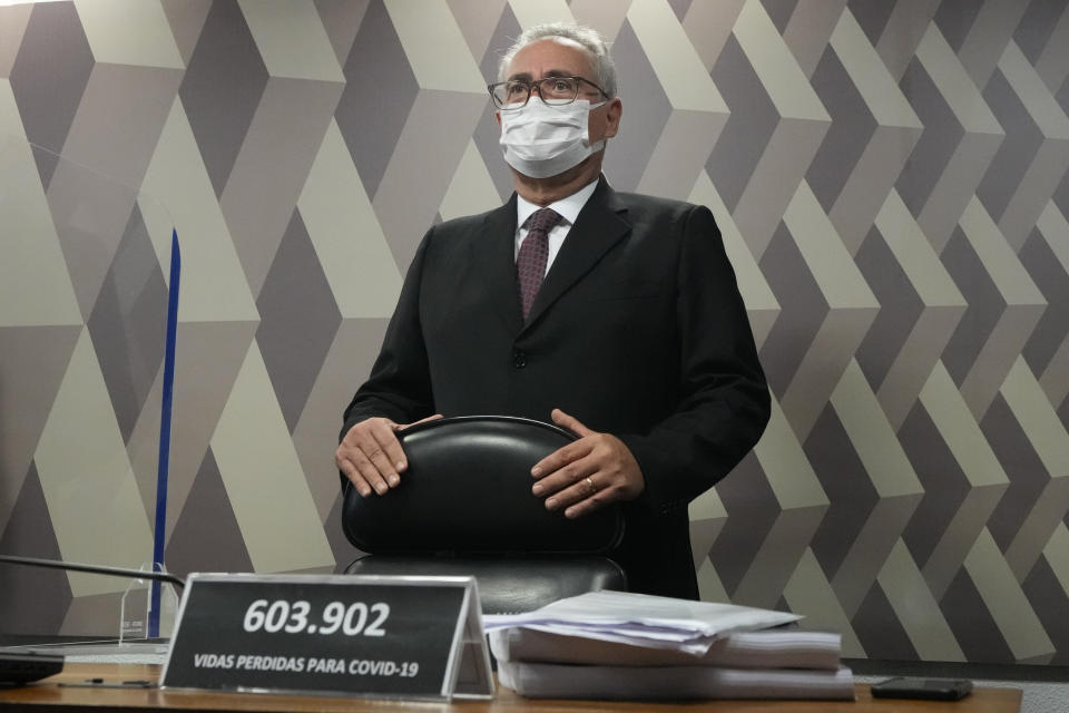 Senator Renan Calheiros stands behind a plaque with the number of COVID-19 deaths in Brazil during a session by the commission investigating the government's management of the COVID-19 pandemic at the Federal Senate in Brasilia, Brazil, Wednesday, Oct. 20, 2021. Calheiros formally presented a report recommending President Jair Bolsonaro be indicted on criminal charges for allegedly bungling Brazil's response to pandemic and pushing the country's death toll to second-highest in the world. (AP Photo/Eraldo Peres)