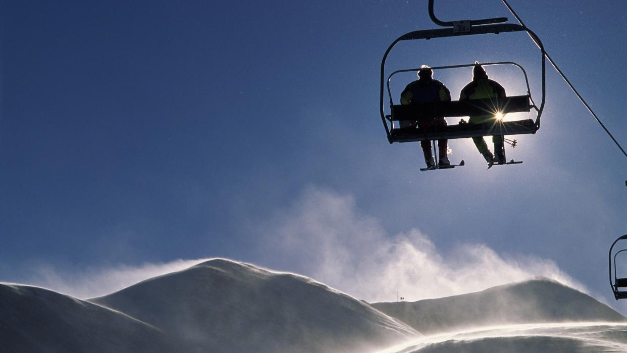  Skiers on chair lift at Breckenridge ski resort. 